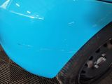 a close up of a blue car with a black rim