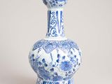 blue and white vase with a floral design on the bottom