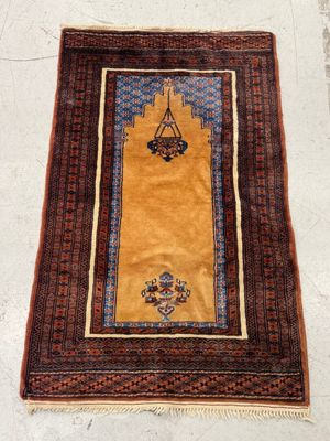 a yellow rug with a blue and red design on it