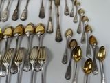 a lot of silver spoons and spoon spoons on the table
