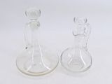 two glass vases sitting next to each other on a white surface