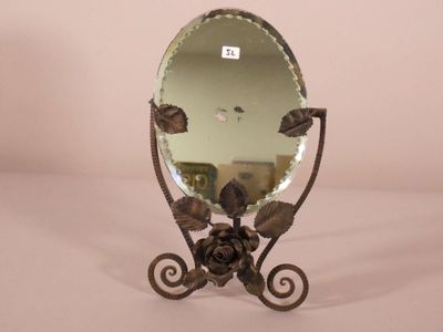 a mirror with a flower on it on a stand