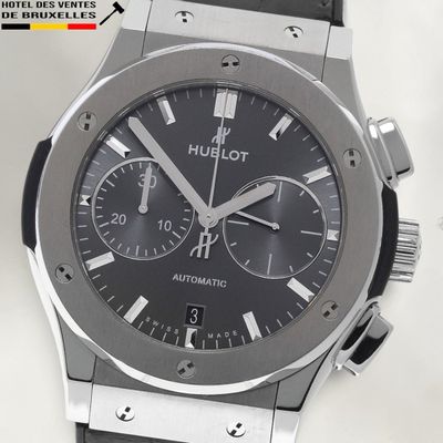 a close up of a watch with a black dial