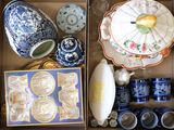 une boîte remplie de vaisselle en porcelaine bleue et blanche et d'autres objets