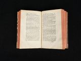 an open book on a black surface with a black background