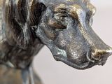 a statue of a dog that is on a table