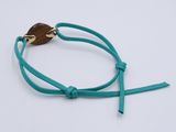 a close up of a bracelet on a white surface