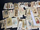 a lot of old religious cards on the table
