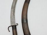 two knives are shown on a white surface with a black handle