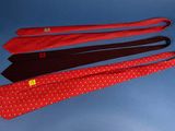 four ties are lined up in a row on a blue surface