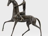 a bronze statue of a man riding a horse