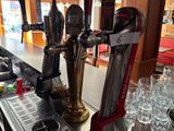 a bar with a bunch of beer taps on it
