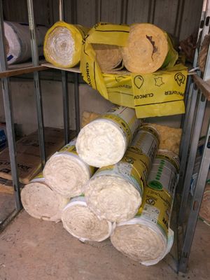 a stack of rolled up rolls of fabric next to a stack of rolled up rolls