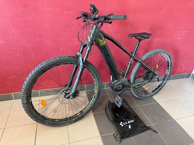 a bike that is sitting on the floor next to a bag