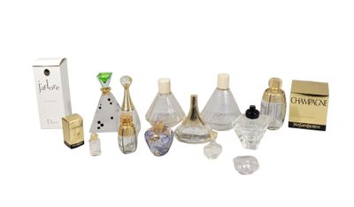 many different bottles of perfume sitting on a white surface