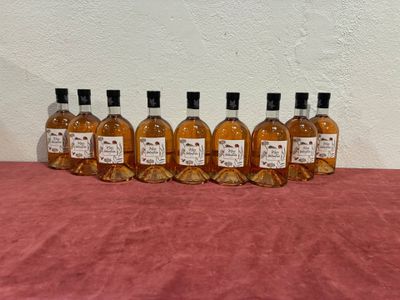 six bottles of liquor lined up on a table
