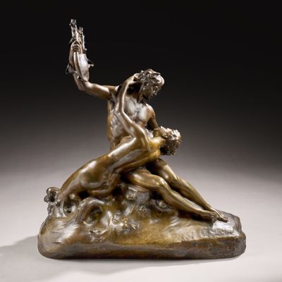 a bronze statue of a woman and a man sitting on a rock