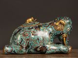 a blue and gold figurine of an elephant on a table