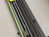 a close up of a metal rail with a yellow sticker on it