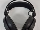 a pair of black headphones sitting on top of a white surface