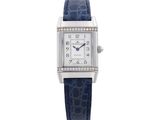 a close up of a watch on a white background with a blue strap