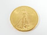 a close up of a gold coin on a white surface