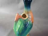 a ceramic bird that is sitting on a table