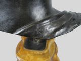 sculpture of a hat on a wooden base with a black hat on top