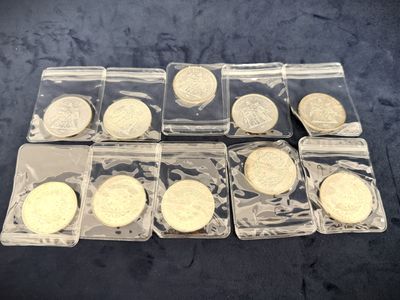 six different types of coins in plastic bags on a table
