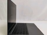an open laptop computer sitting on top of a white surface