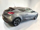 a picture of a silver car in a white room