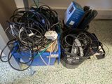 many wires that are tangled up on the floor