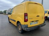 a yellow van that is parked in a parking lot