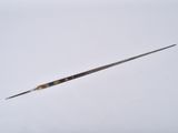 a close up of a small wooden stick on a white surface