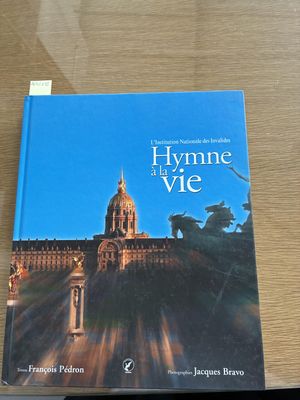 a book on a table with a picture of a building in the background
