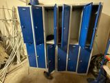 several blue lockers in a room that is being remodeled