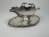 a silver plate with a bowl and saucer on it
