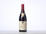 a bottle of red wine sitting on top of a table