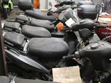 a lot of motorcycles that are parked in a garage