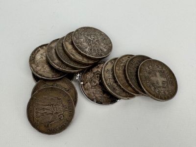 a pile of coins sitting on top of a white table