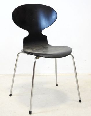 an image of a black chair against a white wall
