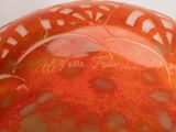 a close up of a red vase with writing on it