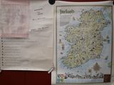 a map hanging on a wall with a bunch of other things