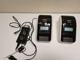 two cell phones sitting next to each other on a table