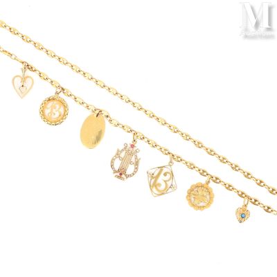 a close up of a gold chain with various charms on it