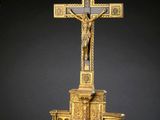 une image représentant une croix en or sur laquelle est représenté un homme