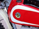 a red and white motorcycle parked on the side of the road