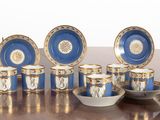 a table with a bunch of blue and white cups and saucers on it
