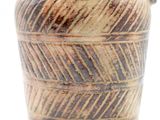 a brown vase with a handle on a white surface