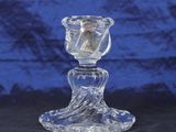 a close up of a glass candle holder on a table